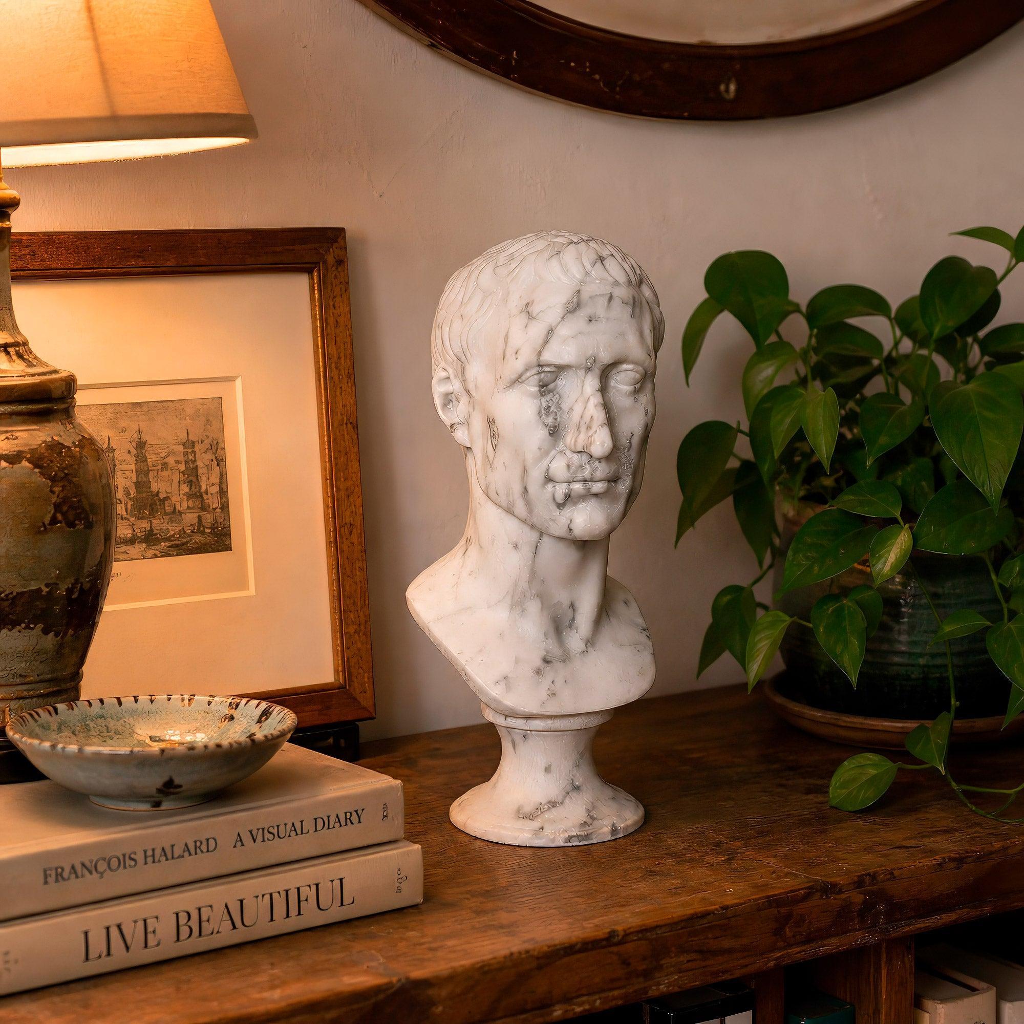 Busto di Giulio Cesare in marmo bianco di Carrara, vista a tre quarti ambientato in un salotto.