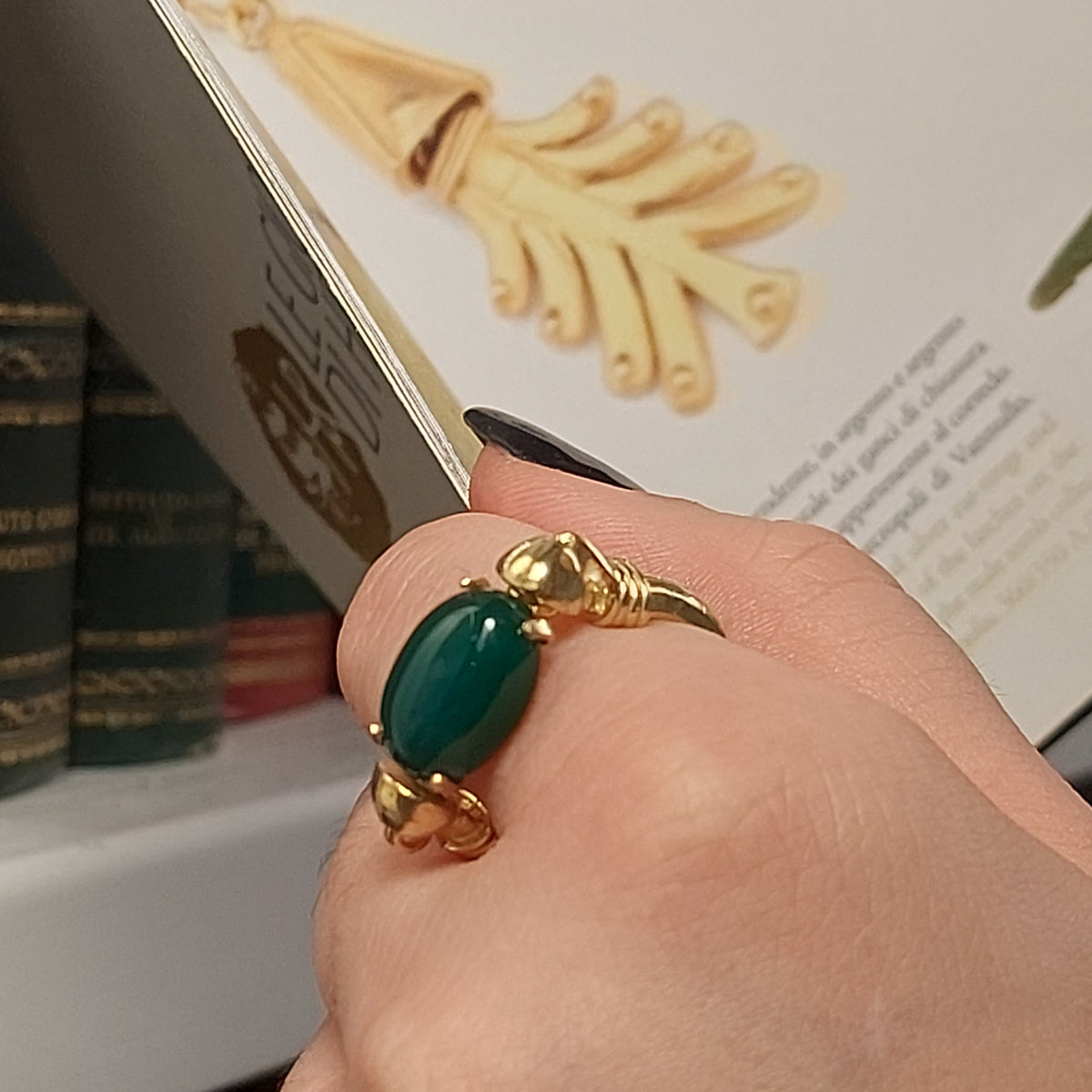 Gold ring with natural green stone worn