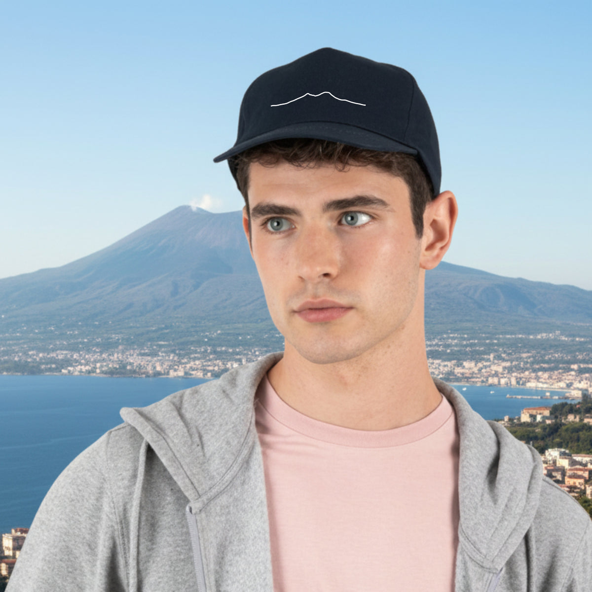 Modèle portant une casquette bleue avec broderie du Vésuve, vue de face.