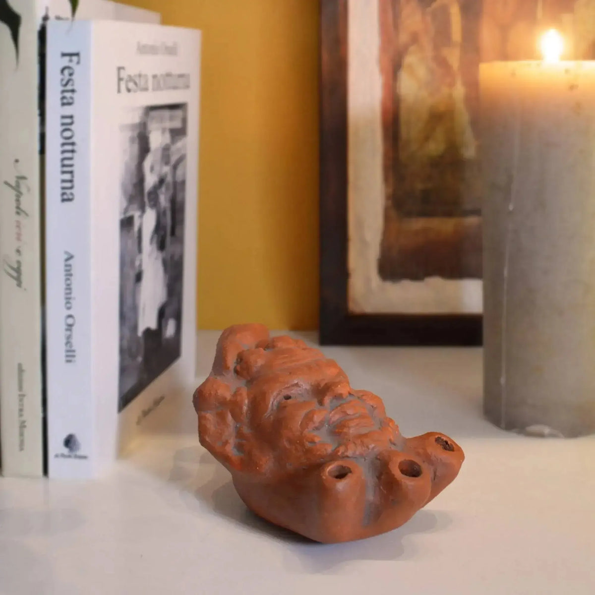 terracotta oil lamp depicting the satyr of the three fires