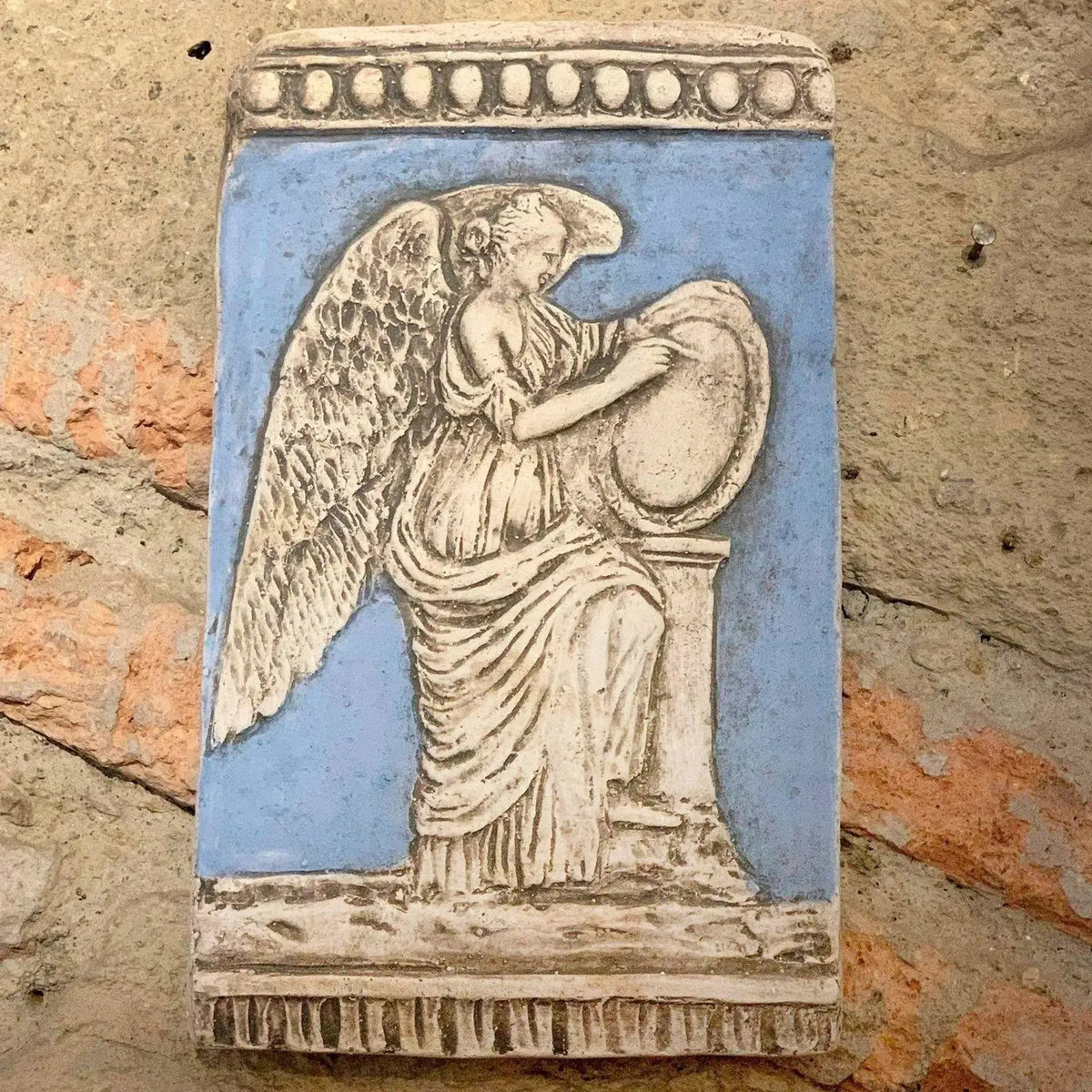 Blue terracotta plaque depicting the winged goddess of victory, Nike, taken from Trajan's column in Rome